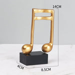Goldene Musiknoten im 3er-Set auf schwarzem Sockel
