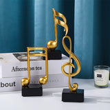 Goldene Musiknoten im 3er-Set auf schwarzem Sockel