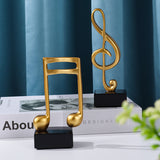 Goldene Musiknoten im 3er-Set auf schwarzem Sockel