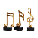 Goldene Musiknoten im 3er-Set auf schwarzem Sockel