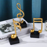 Goldene Musiknoten im 3er-Set auf schwarzem Sockel